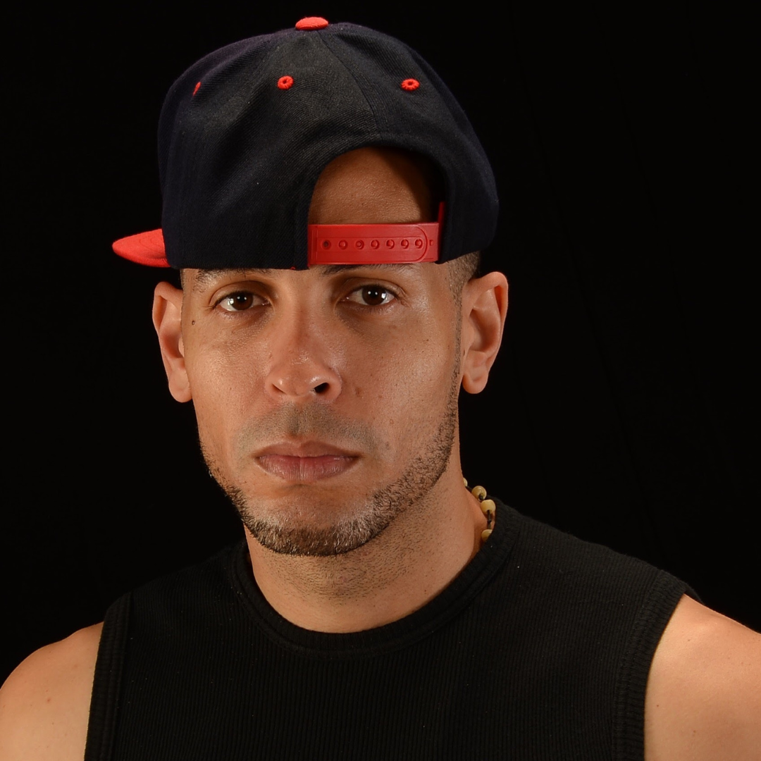 JD Analitico wearing a black and red cap